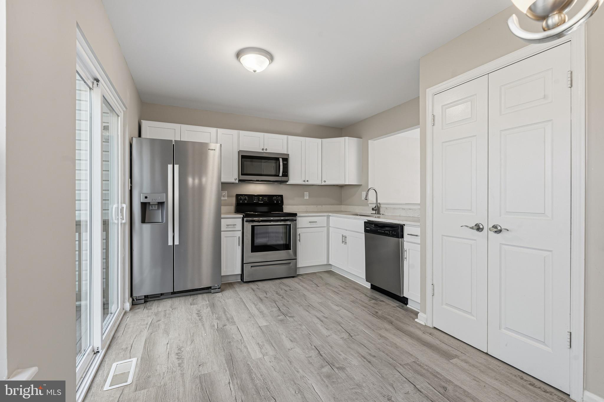 3365 Cheverly Court, Unit 3365 Abingdon, MD 21009 - Photo 9 of 32 a kitchen with a refrigerator a stove top oven a sink and cabinets