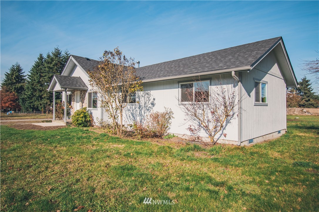 8414 183rd Avenue Southwest Rochester, WA 98579 - Photo 2 of 19 a view of a house with yard and a garden