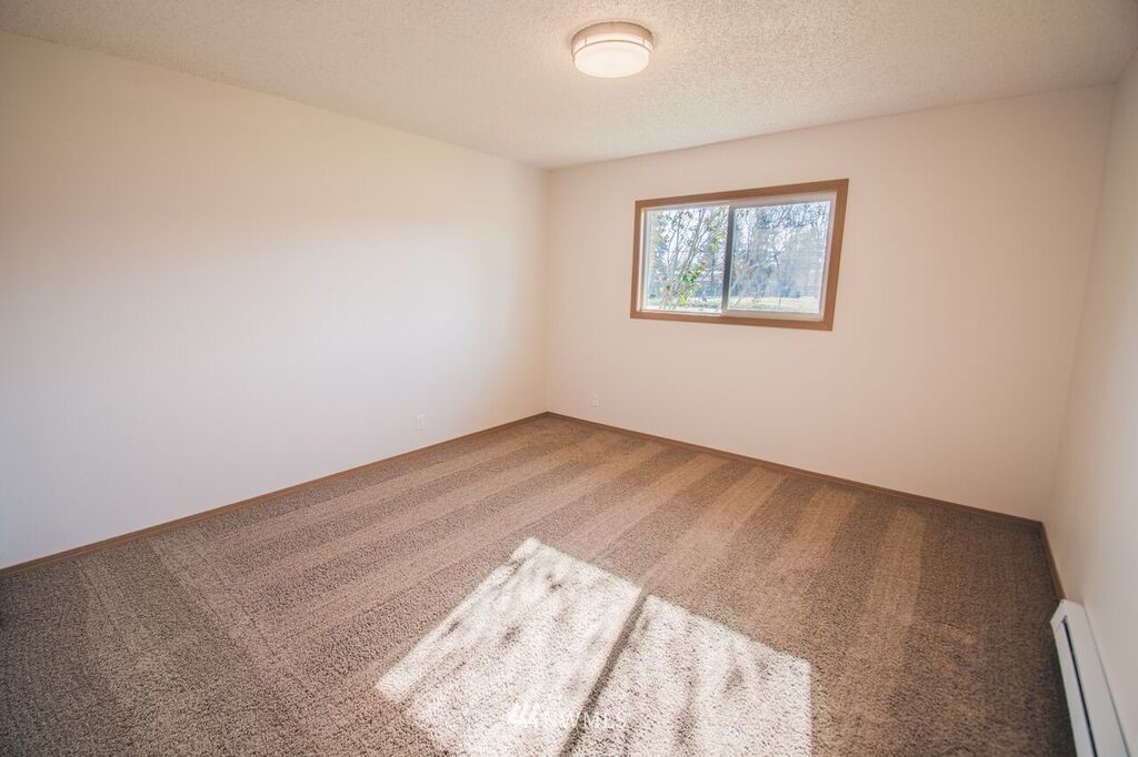 8414 183rd Avenue Southwest Rochester, WA 98579 - Photo 11 of 19 an empty room with a window