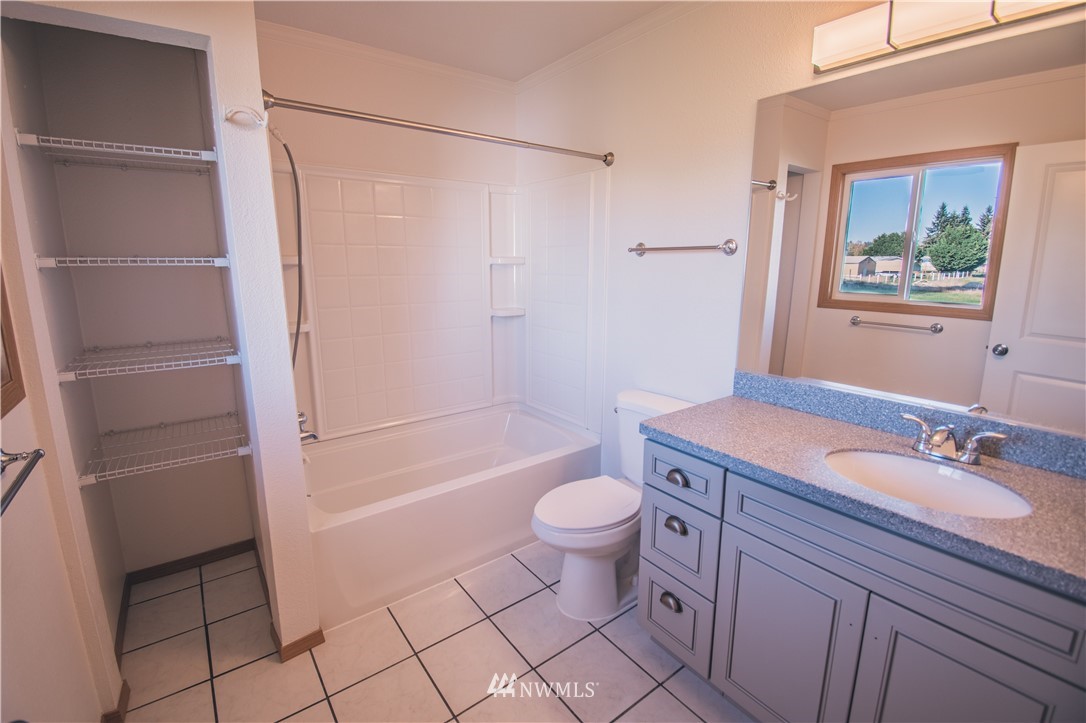 8414 183rd Avenue Southwest Rochester, WA 98579 - Photo 17 of 19 a bathroom with a granite countertop sink toilet and shower