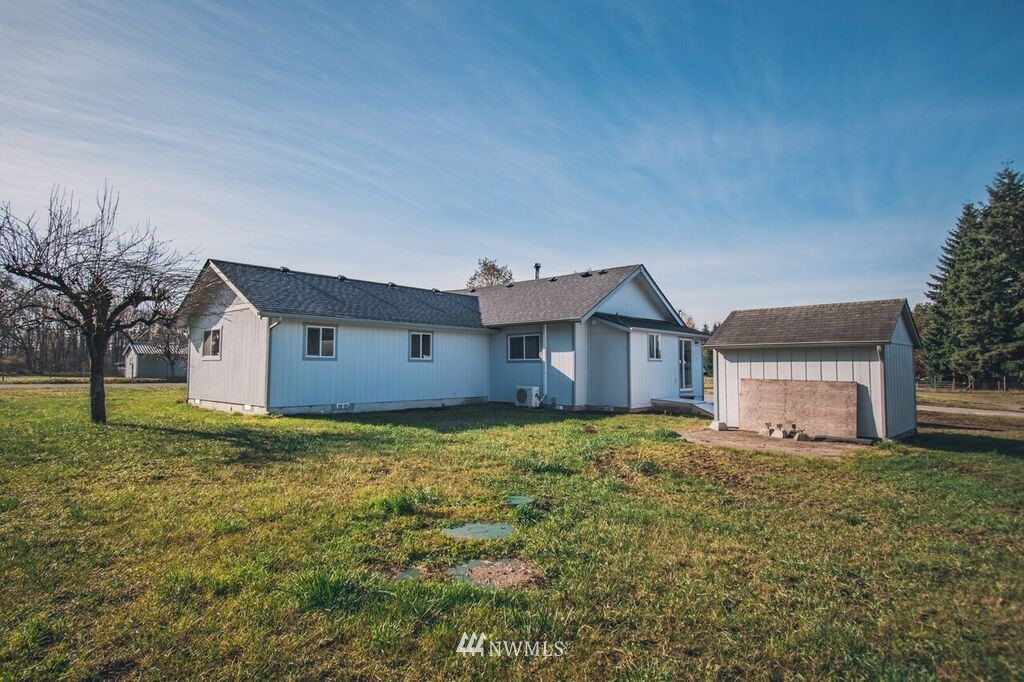 8414 183rd Avenue Southwest Rochester, WA 98579 - Photo 19 of 19 a house with huge green field in front of it