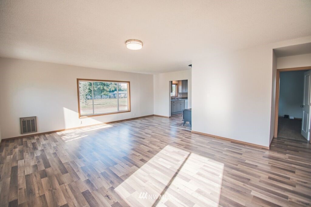 8414 183rd Avenue Southwest Rochester, WA 98579 - Photo 5 of 19 wooden floor in an empty room with a window