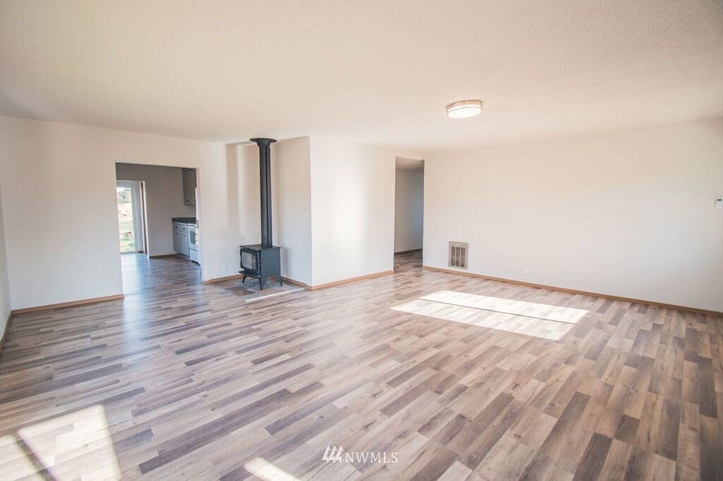 8414 183rd Avenue Southwest Rochester, WA 98579 - Photo 6 of 19 a view of empty room with wooden floor and window