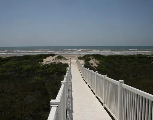 a view of a balcony next to a yard