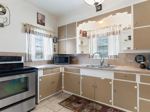 a kitchen with a sink stove and cabinets