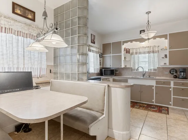 a kitchen with a table chairs and a wooden floor