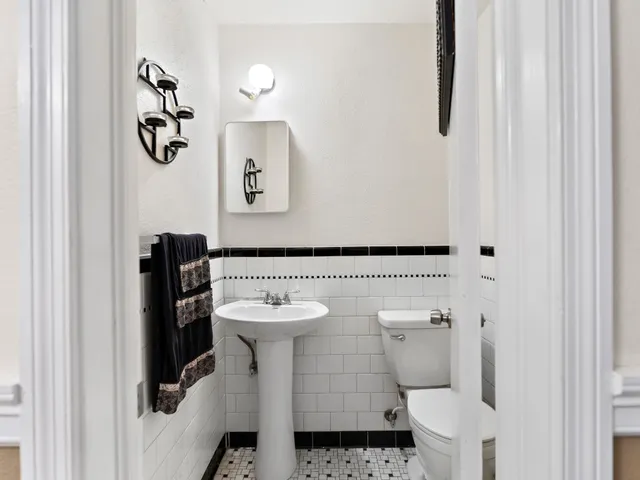 a room with furniture a flat screen tv and a window