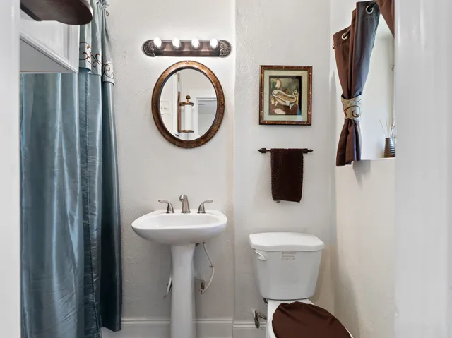 a view of a hallway with wooden floor and entryway