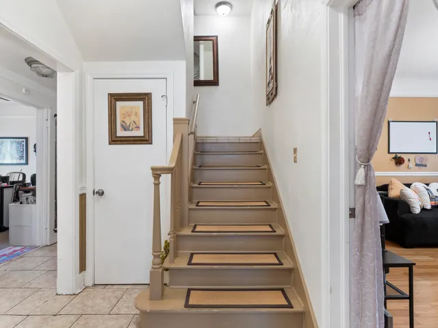 a living room with furniture and a mirror