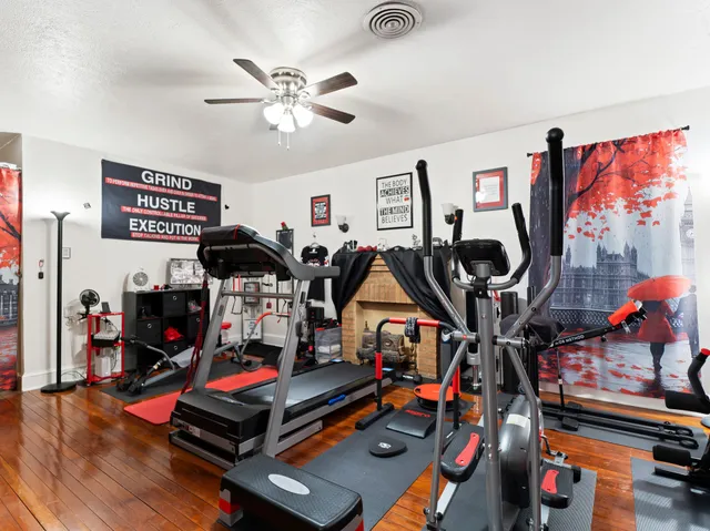 a living room with furniture and a book shelf
