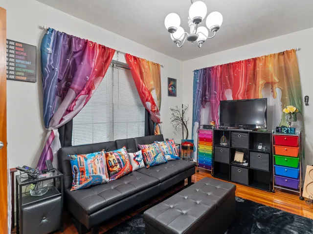 a living room with furniture and a mirror