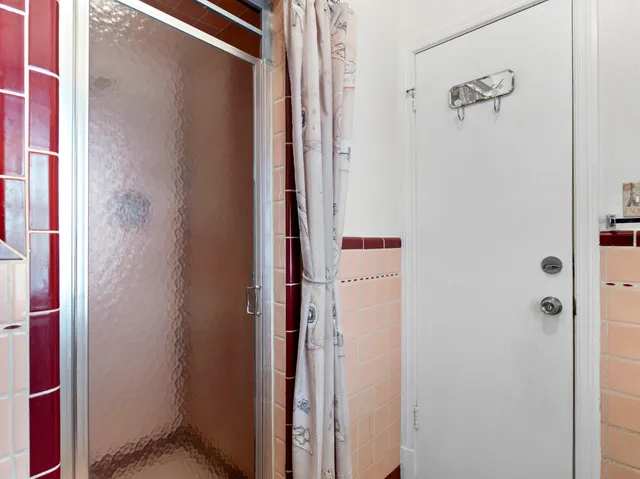 a view of a house with a yard and potted plants