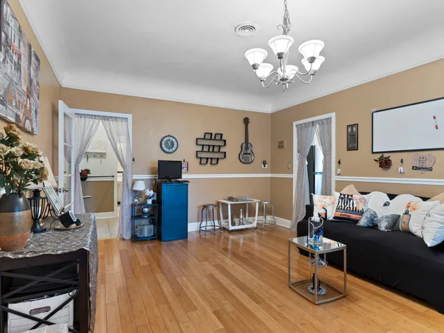 a living room with furniture and kitchen view