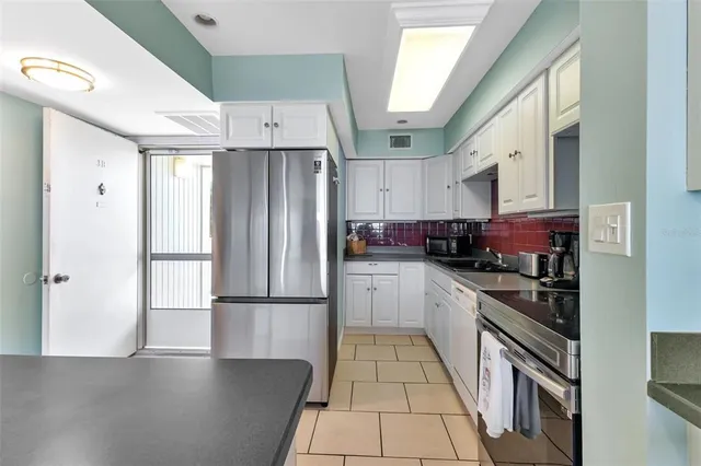 a kitchen with a refrigerator and cabinets