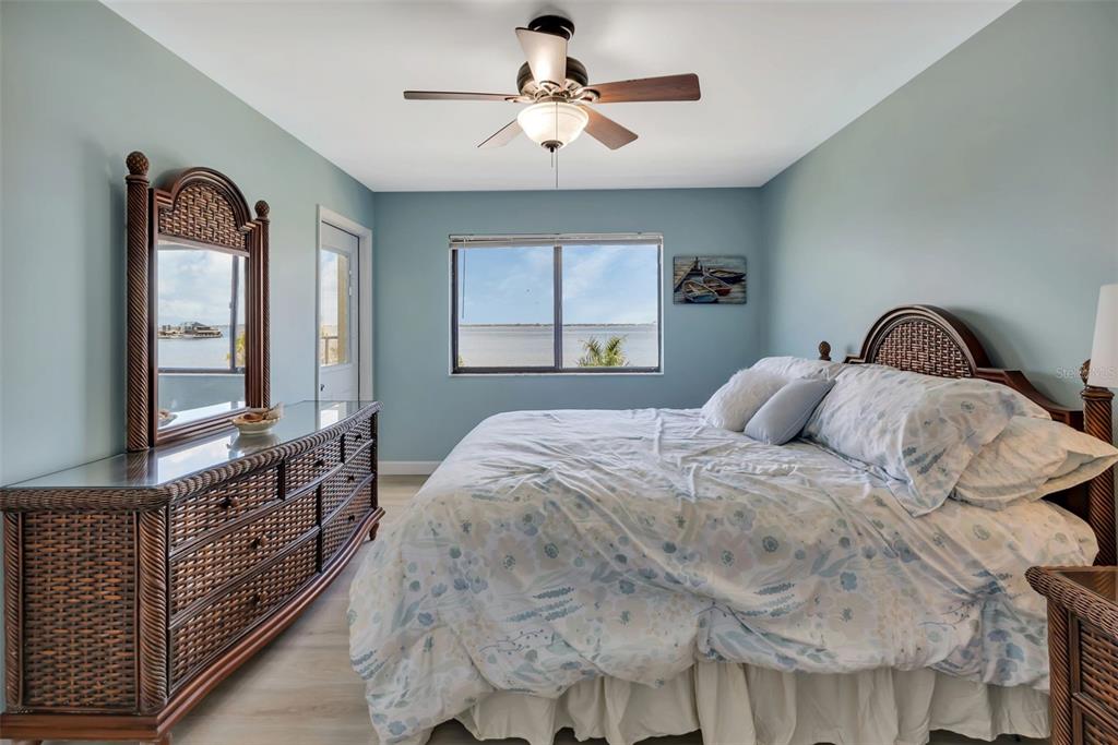 1500 Park Beach Circle, Unit 3B Punta Gorda, FL 33950 - Photo 28 of 57 a bedroom with a bed and a chandelier