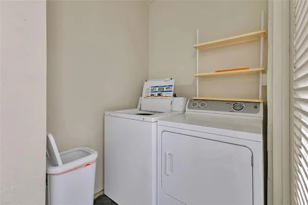 a view of a balcony with wooden chairs and lake view
