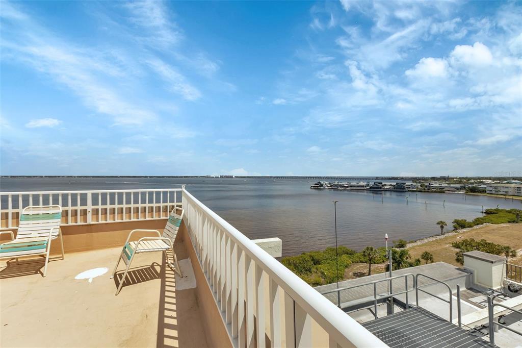 1500 Park Beach Circle, Unit 3B Punta Gorda, FL 33950 - Photo 37 of 57 a view of a balcony with wooden chairs and lake view
