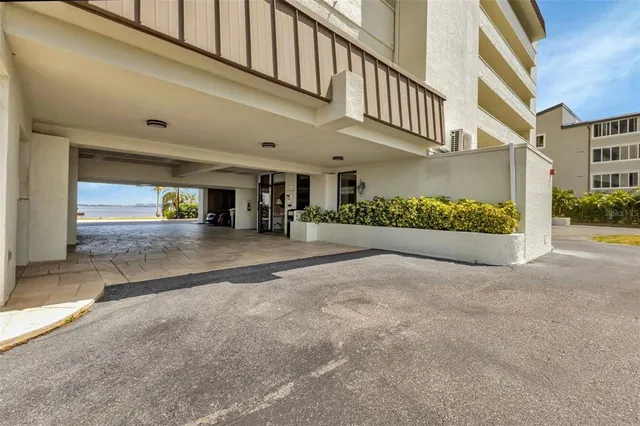a front view of a building with lake view and tall buildings