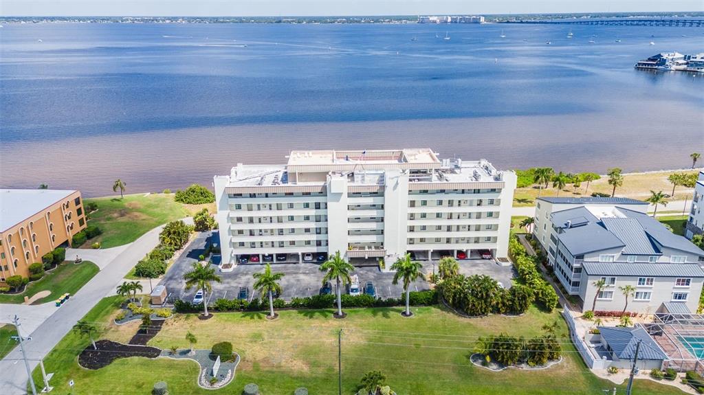 1500 Park Beach Circle, Unit 3B Punta Gorda, FL 33950 - Photo 49 of 57 a view of a multi story residential apartment building with a yard