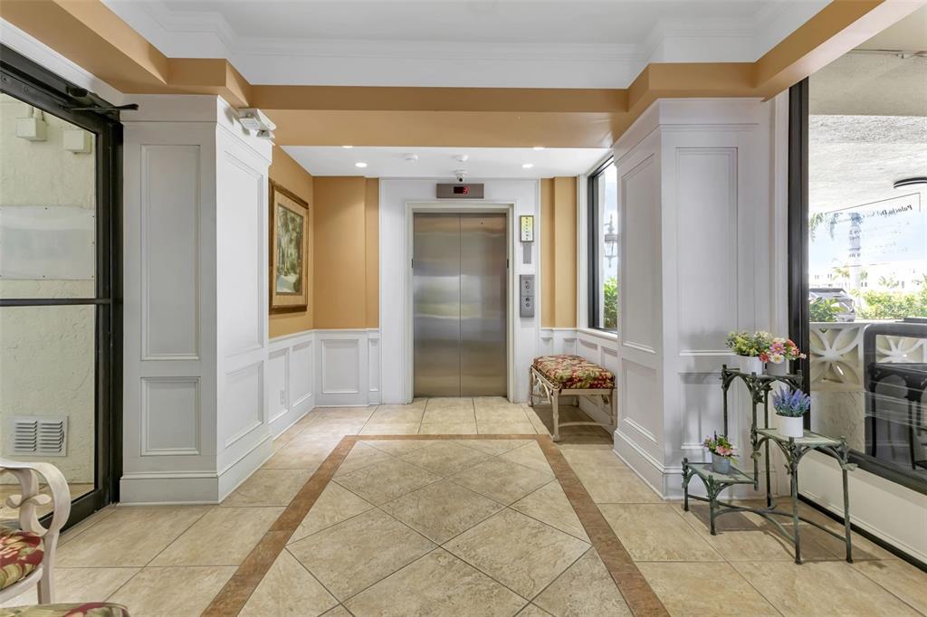 1500 Park Beach Circle, Unit 3B Punta Gorda, FL 33950 - Photo 7 of 57 a hallway with dining area and glass windows