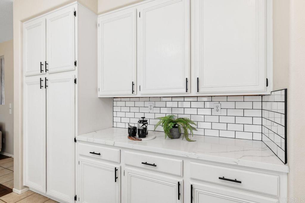 160 Belflora Way Oceanside, CA 92057 - Photo 12 of 41 a sink with white wooden cabinets