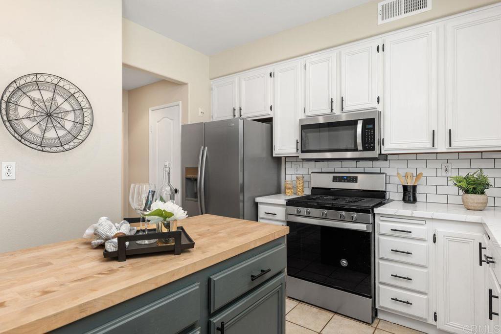 160 Belflora Way Oceanside, CA 92057 - Photo 14 of 41 a kitchen with stainless steel appliances a stove refrigerator and cabinets