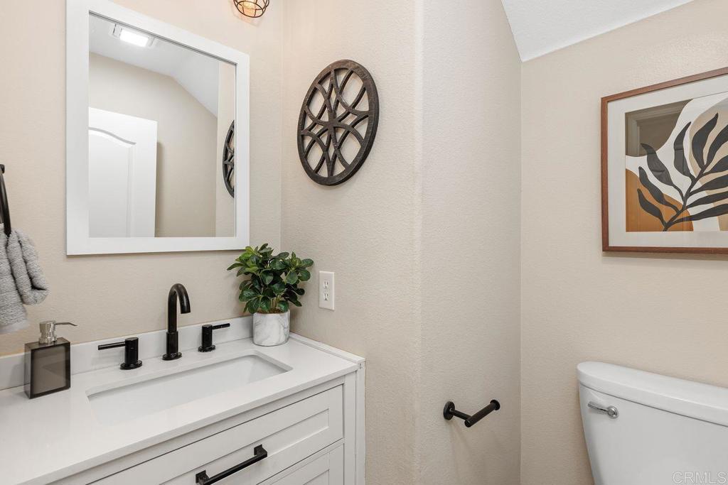 160 Belflora Way Oceanside, CA 92057 - Photo 16 of 41 a bathroom with a sink and a mirror