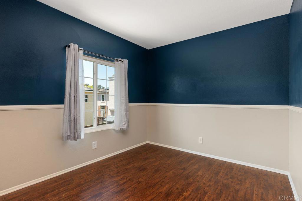 160 Belflora Way Oceanside, CA 92057 - Photo 24 of 41 a view of an empty room with wooden floor and a window