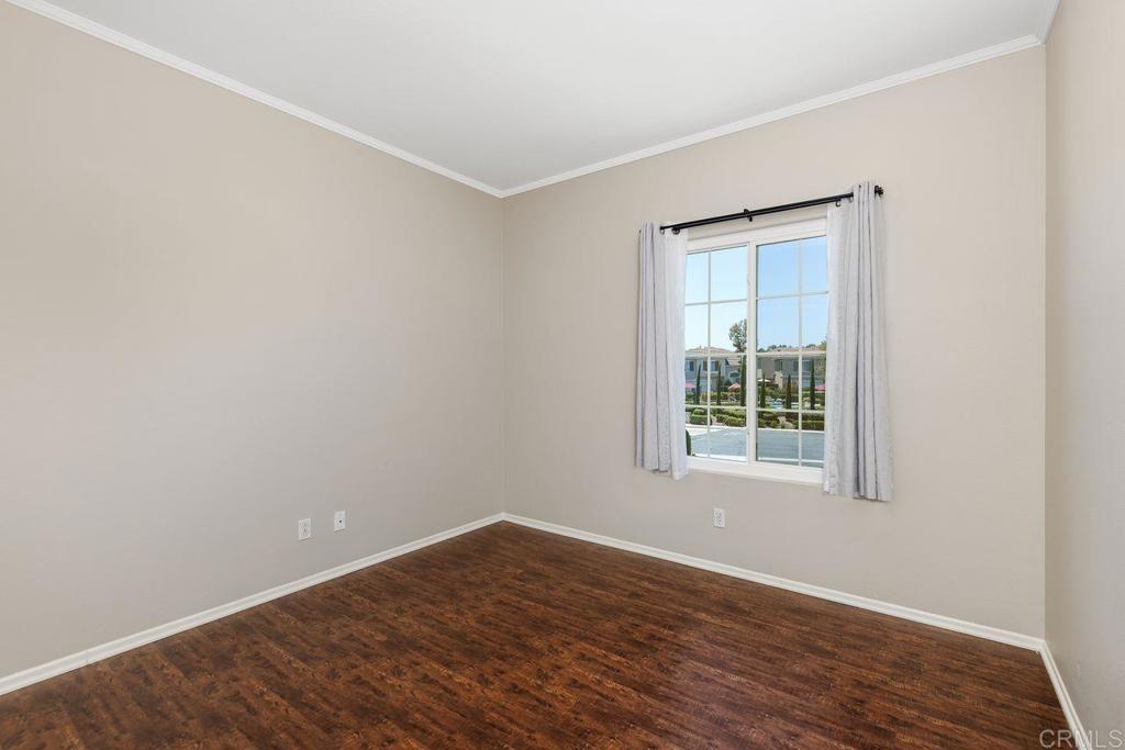 160 Belflora Way Oceanside, CA 92057 - Photo 26 of 41 a view of an empty room with wooden floor and a window
