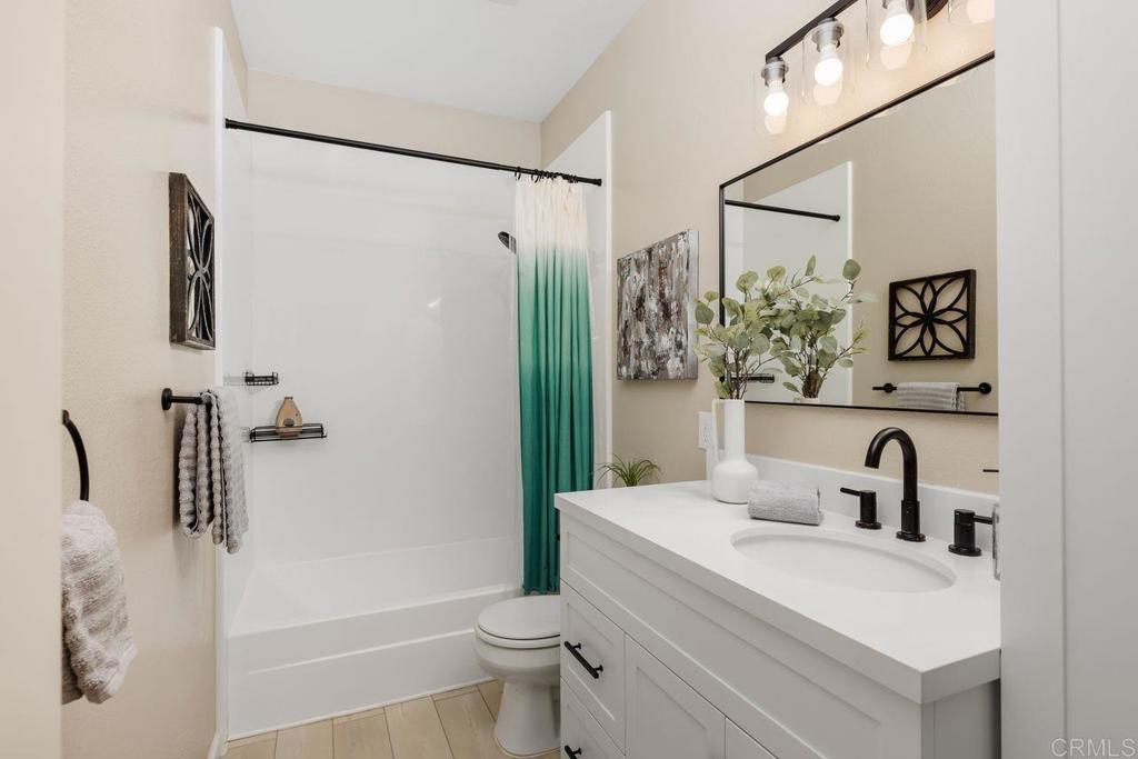 160 Belflora Way Oceanside, CA 92057 - Photo 28 of 41 a bathroom with a sink a toilet and shower