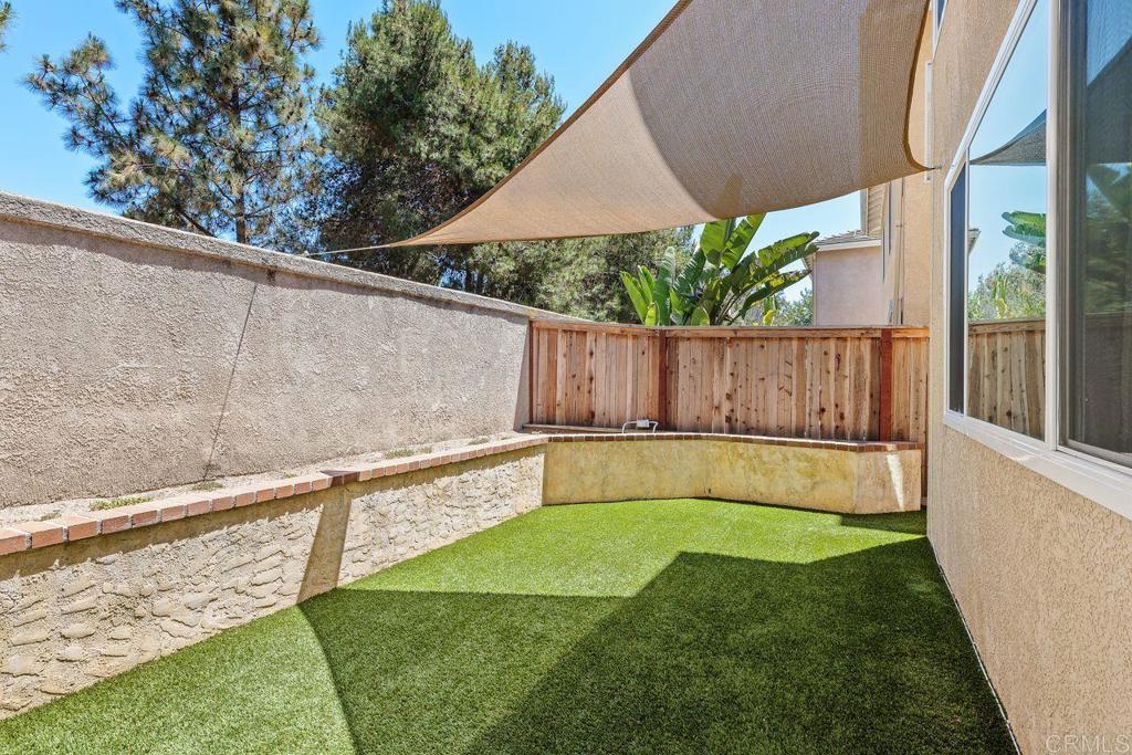 160 Belflora Way Oceanside, CA 92057 - Photo 33 of 41 a view of a backyard with a small pool and wooden fence
