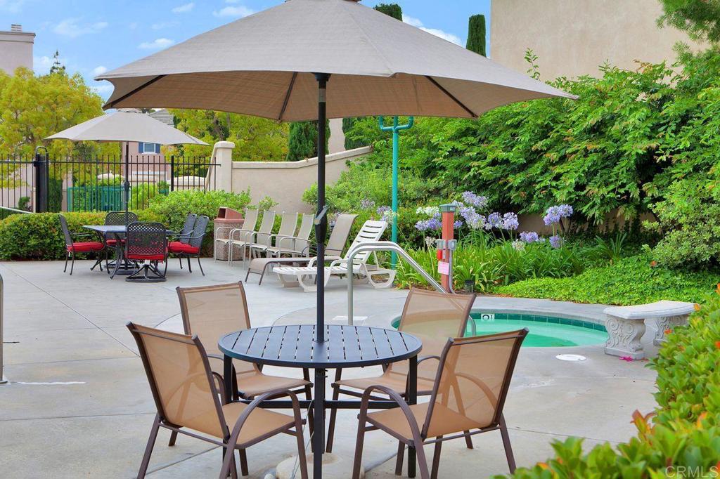 160 Belflora Way Oceanside, CA 92057 - Photo 38 of 41 a patio with a table and chairs under an umbrella