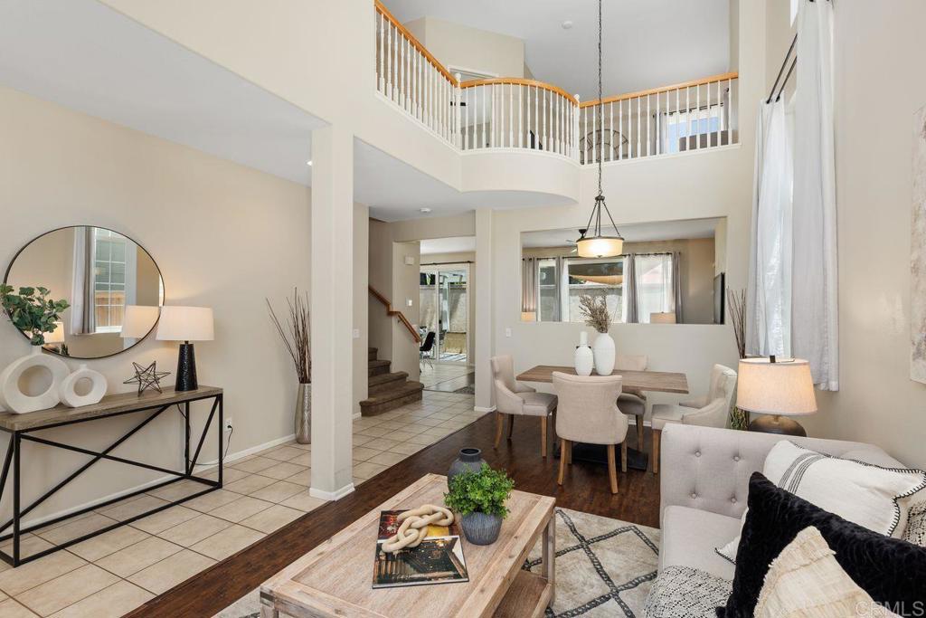 160 Belflora Way Oceanside, CA 92057 - Photo 7 of 41 a dining room with furniture a rug and a chandelier