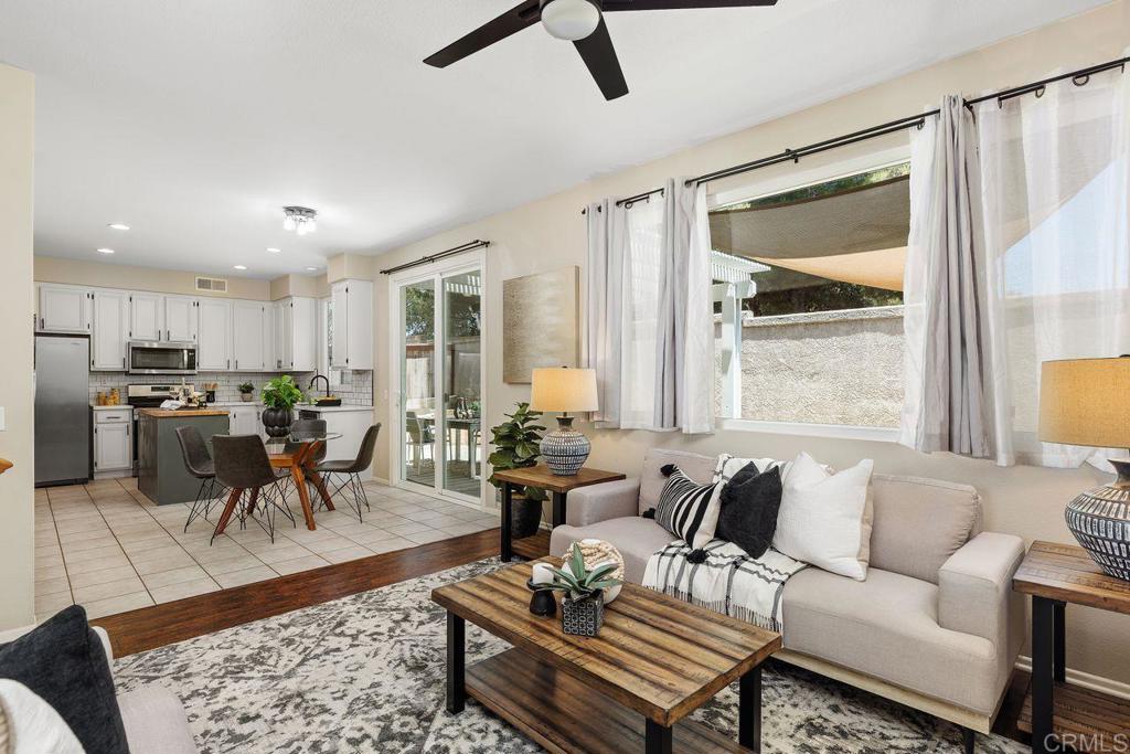 160 Belflora Way Oceanside, CA 92057 - Photo 10 of 41 a living room with furniture kitchen view and a large window