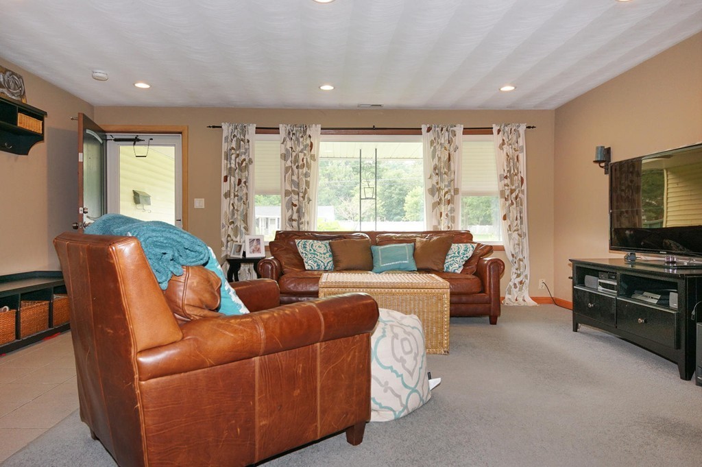 9 Howard Road Chelmsford, MA 01824 - Photo 3 of 13 a living room with furniture and a flat screen tv