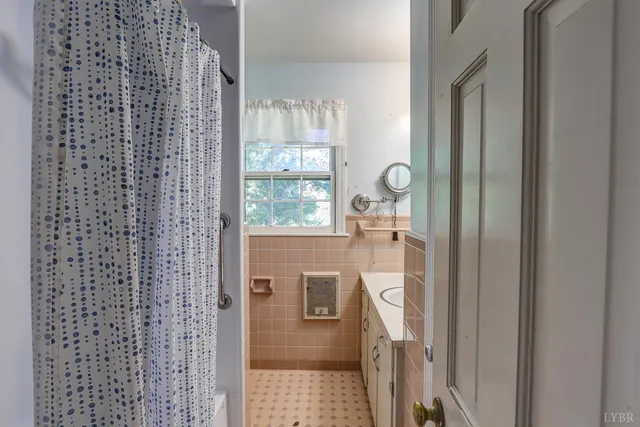 an empty room with wooden floor closet and windows