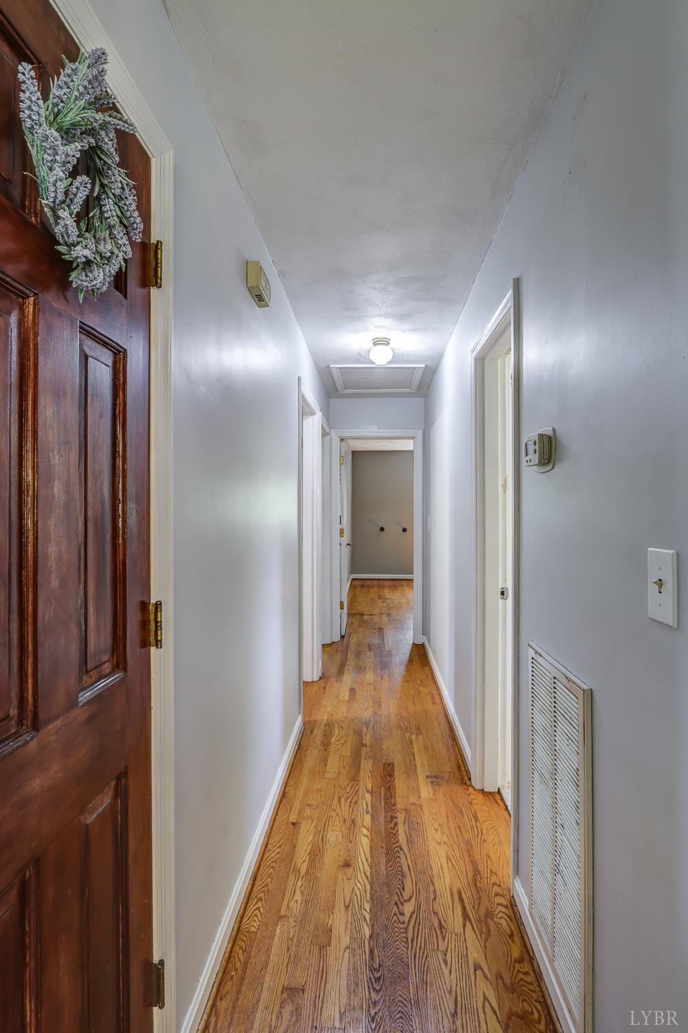 116 Bryant Road Lynchburg, VA 24502 - Photo 31 of 62 a view of a hallway with wooden floor and a bathroom