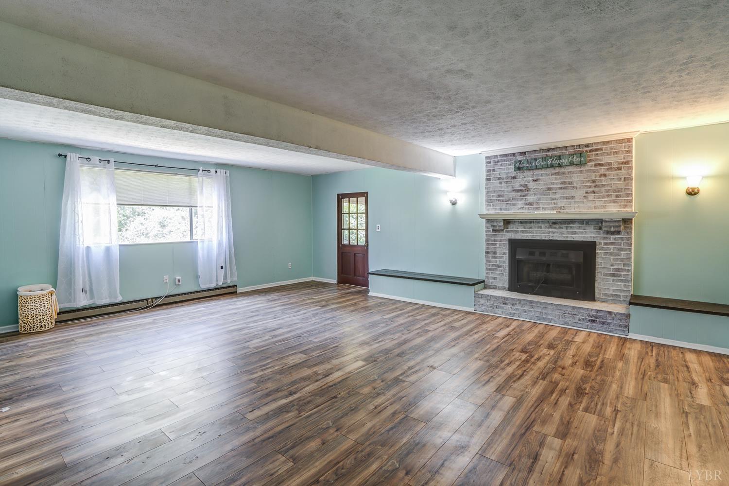 116 Bryant Road Lynchburg, VA 24502 - Photo 32 of 62 an empty room with wooden floor fireplace and windows