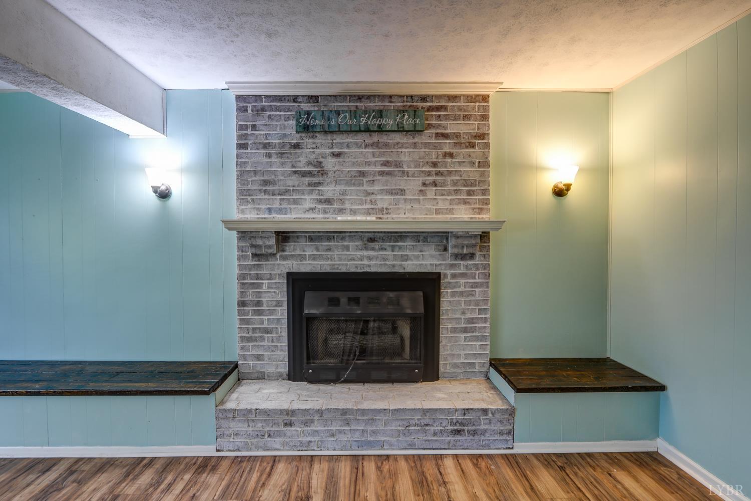 116 Bryant Road Lynchburg, VA 24502 - Photo 34 of 62 a living room with a fireplace and a wooden floor