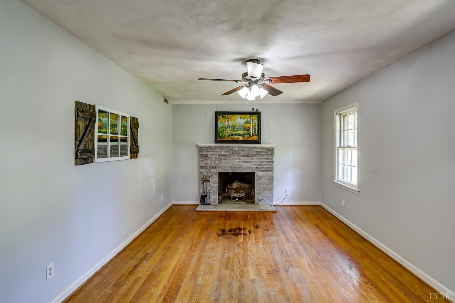 116 Bryant Road Lynchburg, VA 24502 - Photo 4 of 62 a view of a livingroom with wooden floor a fireplace and windows