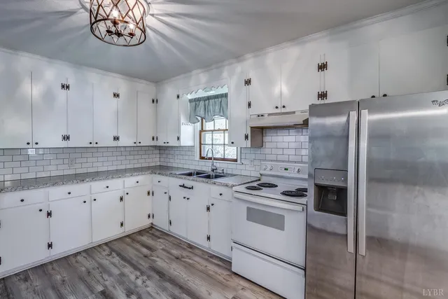 a kitchen with cabinets appliances and a window