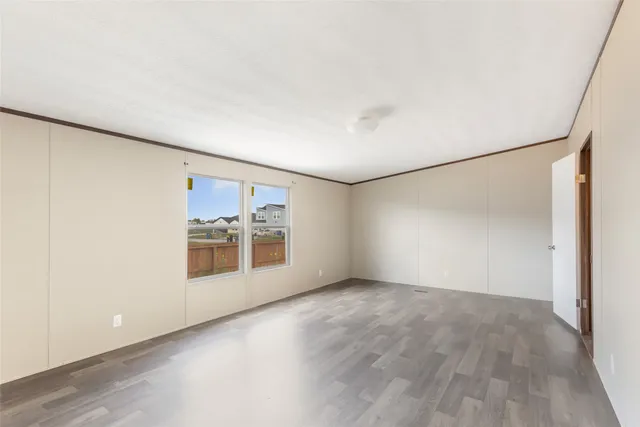wooden floor in an empty room with a window