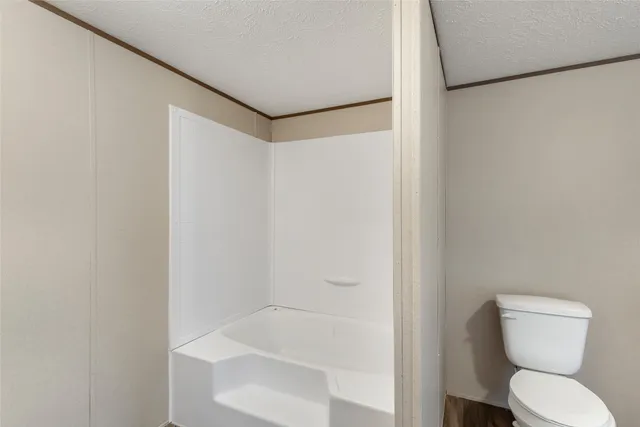 a bathroom with a toilet and a bathtub