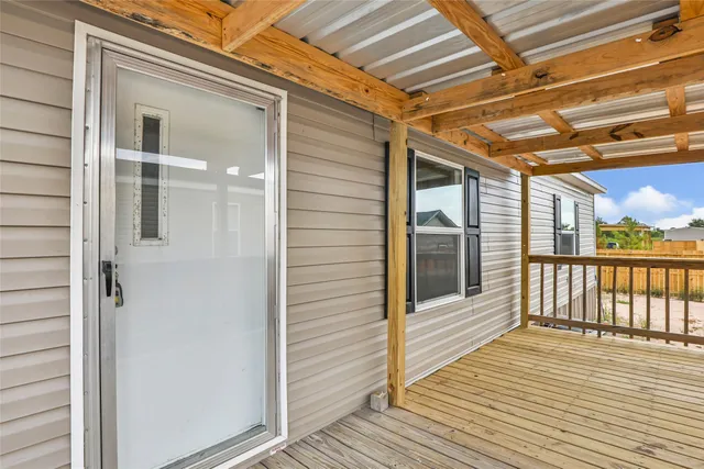 a view of a balcony with wooden floor