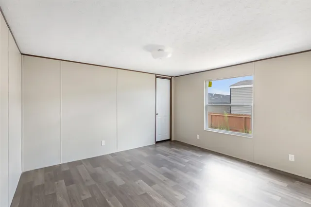an empty room with windows and closet