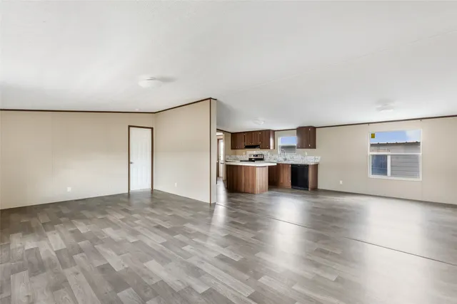 a view of kitchen with stainless steel appliances a refrigerator and a stove top oven
