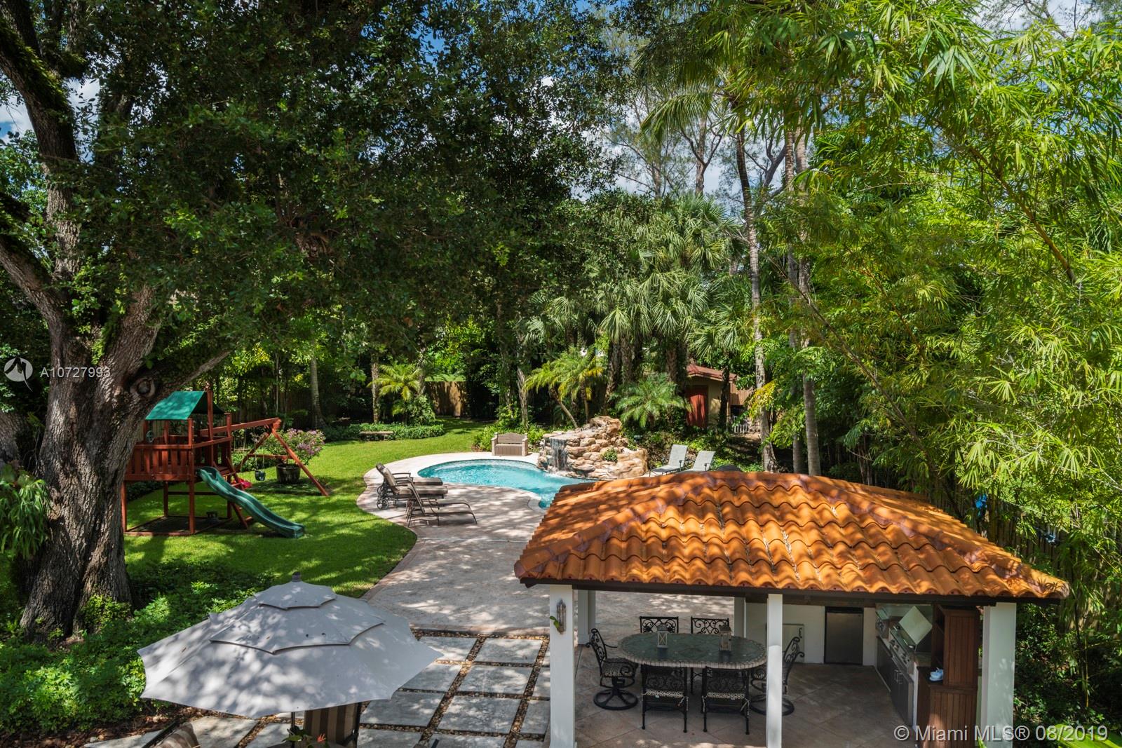 Enjoy this lush, tropical, serene backyard engulfed with a beautiful mature Oak tree.