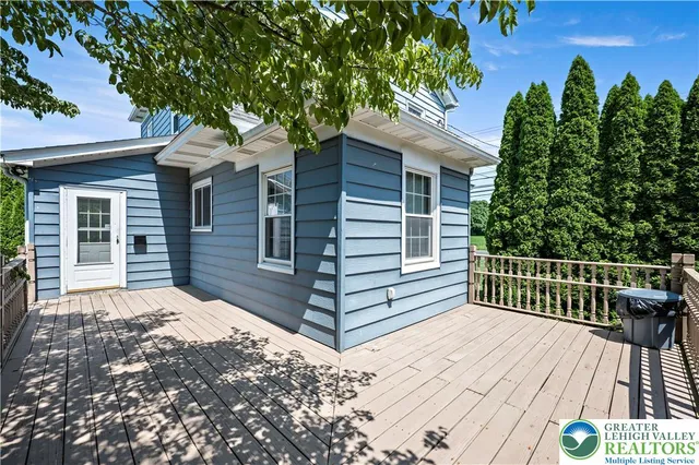a view of backyard with a deck and a garden