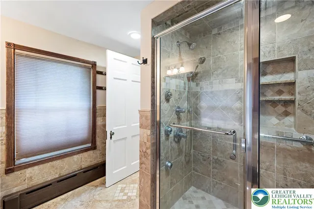a bathroom with a glass shower door