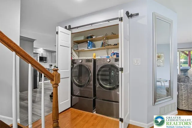 a view of a hallway with washer and dryer